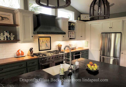 dragonfly glass backsplash art in black and white kitchen