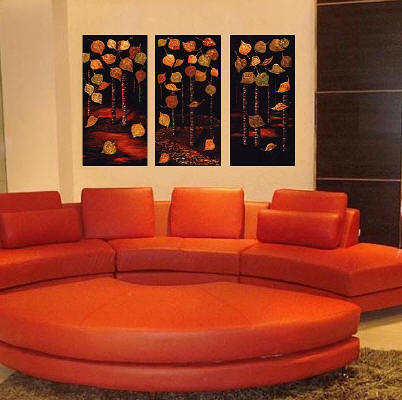 large contemporary paintings of trees over red sofa