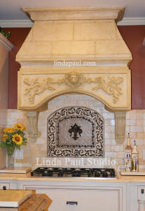 custom kitchen with backsplash medallion and faux stone hood