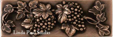 metal border tile of grapes